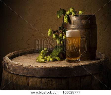 Still life: old wooden pint of beer, glass of beer on the table in the cellar.
