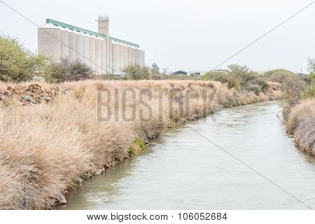 Irrigation Canal And Grain Silos