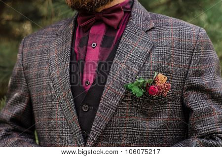 Cool Boutonniere On Hip Trendy Groom At Wedding. Grey Suit, Colorful Vinous Boutonniere. Maroon Bow