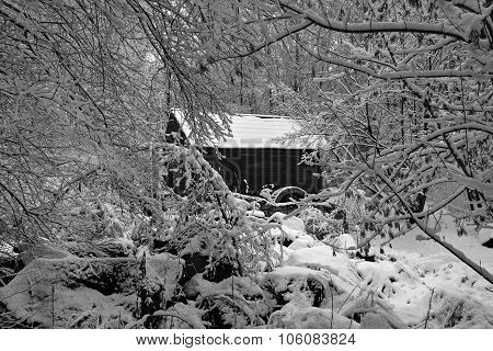 Old Black Wooden House Mill Mill With A Wooden Wheel Standing In A Snowy Winter Forest. Black And Wh