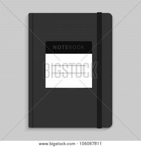 Moleskin notebook with black elastic band image.