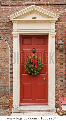 Colonial Red Doorway In Historic Elfreth's Alley In Philadelphia With Pediment And  Christmas Wreath