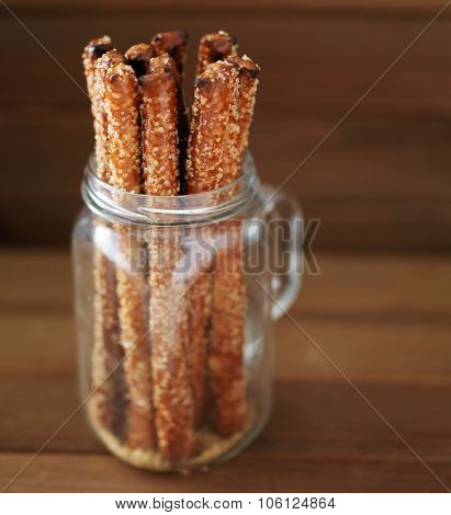 candied pretzel sticks in mason jar with turbinado sugar and sea salt