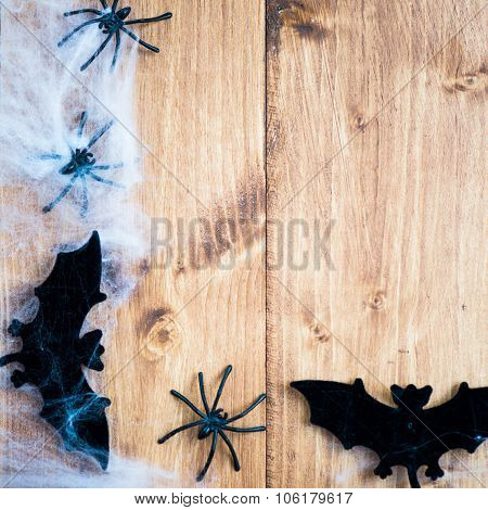 Halloween Symbols Bats, Web And Black Spiders On Wooden Background