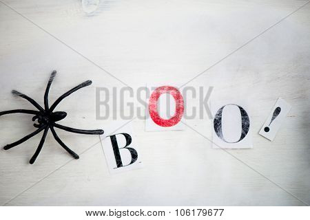 Halloween Symbols Boo Letters In Spiders Web On Wooden Background