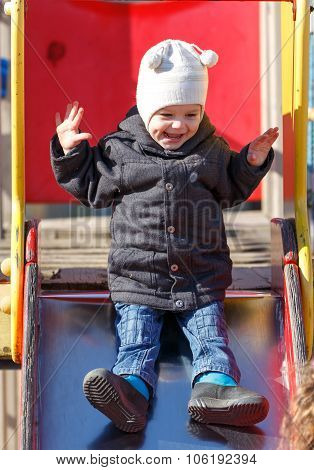 Two Years Old Son Is Sliding Down A Roller Coaster