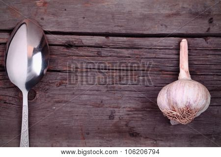 Spoon And Garlic On A Board