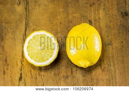 Lemon And Half On The Wood Background
