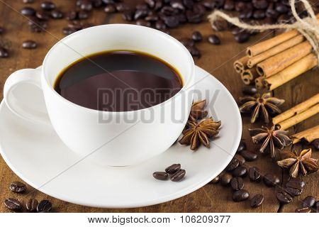 Coffee On The Cup With Coffee Beans And Cinnamon Sticks On Wood Background ,  Warm Toning, Selective