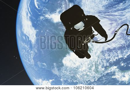 Astronaut in space above the clouds of the Earth..