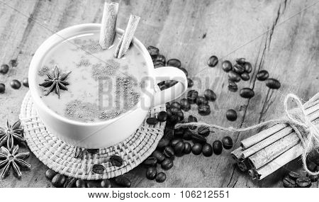 Coffee On The Cup With Coffee Beans And Cinnamon Sticks On Wood Background On Balck And White, Selec