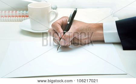 Hand Of Business Man Writing By Pen On Empty White Papeer ,top Table Shot Business Theme