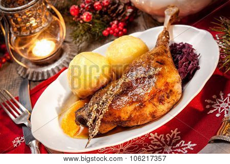 Crusty Christmas goose leg with braised red cabbage and dumplings