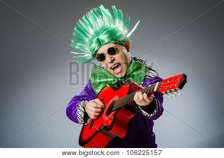 Funny man playing guitar in musical concept