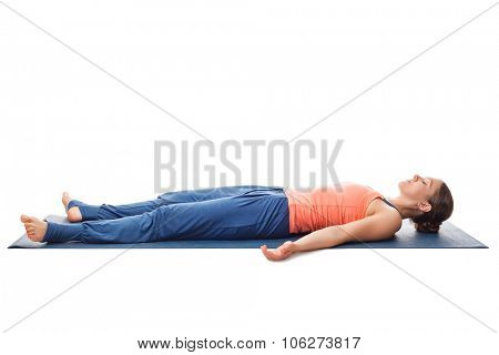 Beautiful sporty fit yogini woman relaxes in yoga asana Savasana - corpse pose isolated on white