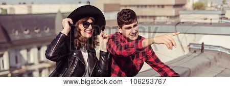 Hipster Couple Sitting On Roof