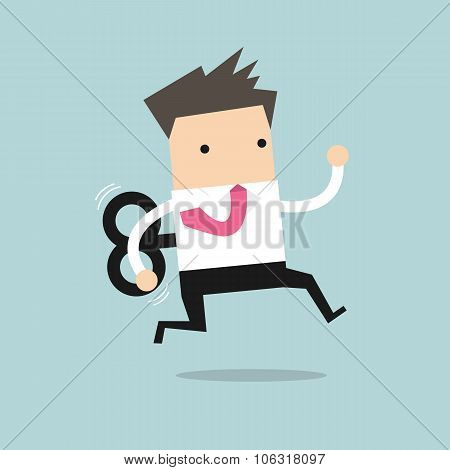 Businessman running with wind-up key