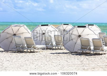 Sun Umbrellas On The Beach Of Ocean. Miami Beach, Florida.