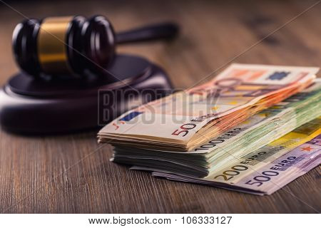udge's hammer gavel. Justice and euro money. Euro currency. Court gavel and rolled Euro banknotes.