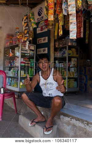 Indonesian Man In Front Of His Store In Manado Shantytown