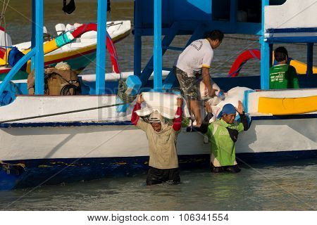 Men Transports Cargo From Ship