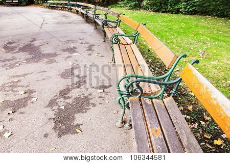 Empty Wooden Benches In City Park