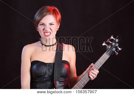 Fashion girl with guitar playing rock