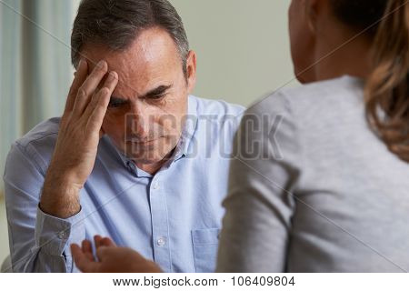 Depressed Mature Man Talking To Counsellor