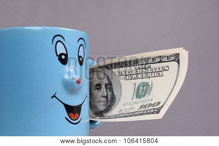 Cup with dollars money in the hand