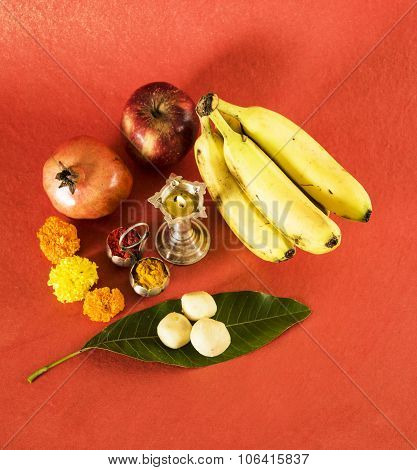 hindu puja elements, diya, haldi kumkum,apple, pomegranate and banana as offering to god and indian