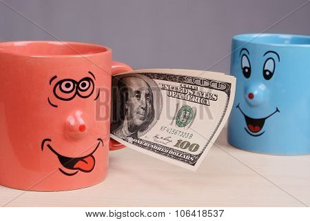 Cup with dollars money in the hand