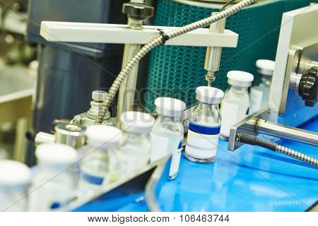 pharmaceutical industry. Close-up of glass bottles ampoules on the line machine conveyor at factory
