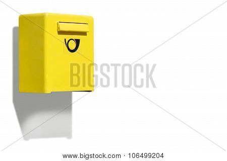 Yellow letterbox on white wall