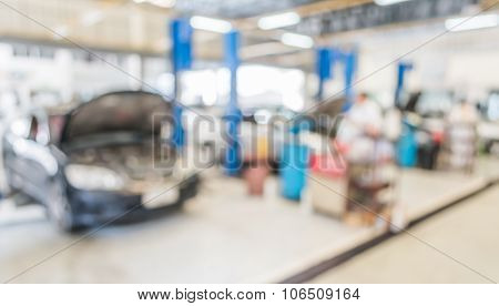 Blur Image Of Worker Fixing Car In Ther Garage.