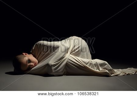 Studio image of mentally ill woman in straitjacket