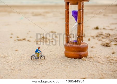 Image Of Mini Figure Dolls Biker And Sandglass On The Beach
