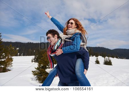 romantic winter  scene, happy young couple having fun on fresh show on winter vacatio, mountain nature landscape
