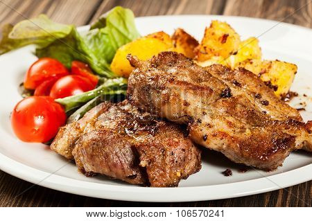 Grilled Steaks, Baked Potatoes And Vegetables