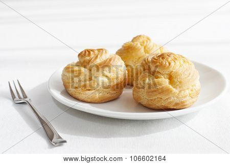 Profiteroles, choux with custard and anglaise, whipped cream, dessert