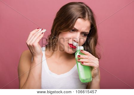 Woman Holding A Lotion And A Cotton Pad