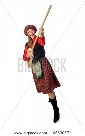 Funny woman in scottish clothing with broom