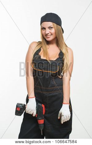 Young sexy female holding a cordless screwdriver