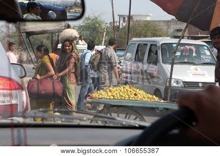 Delhi, India - March 17, 2013 - Indian woman crossing the road in March 17, 2013 in Delhi, India.