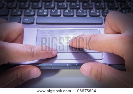 Hands Typing On A Laptop Trackpad