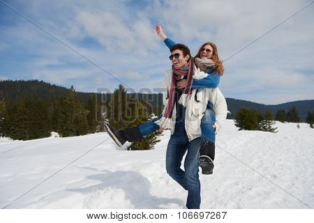 romantic winter  scene, happy young couple having fun on fresh show on winter vacatio, mountain nature landscape