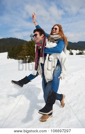 romantic winter  scene, happy young couple having fun on fresh show on winter vacatio, mountain nature landscape
