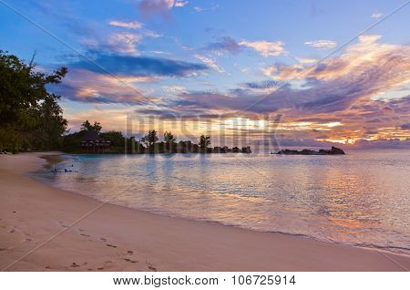 Cafe on Seychelles tropical beach at sunset - nature background