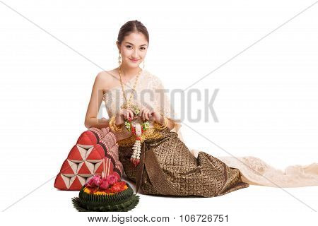 Woman wearing typical thai dress with krathong