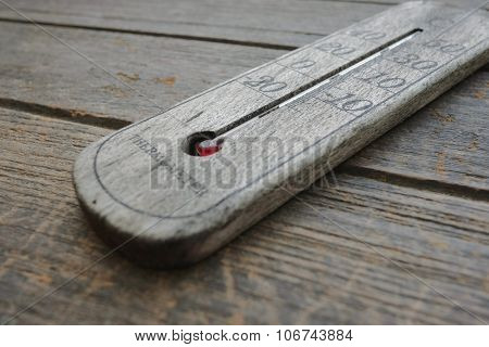 wood thermometer on old wood background