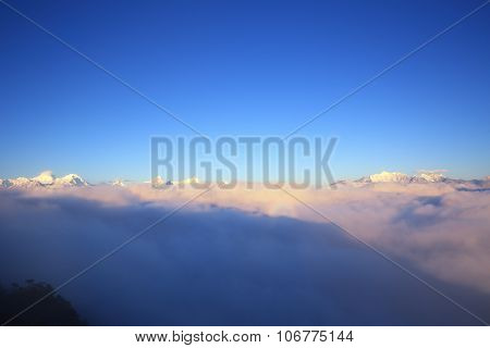beautiful rolling clouds and sunrise on mountain peak landscape